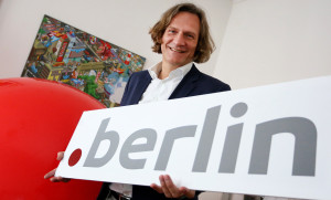 Der Geschäftsführer von dotberlin, Betreiber der neuen Hauptstadt-Domain, Dirk Krischenowski, zeigt am 13.03.2014 ein Schild mit der Aufschrift ".berlin". Foto: Stephanie Pilick/dpa